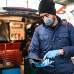 mechanic in front of the van with face mask
